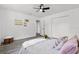 The bedroom features a ceiling fan, closet and lovely wood-look floors at 4112 E Ellicott St, Tampa, FL 33610