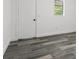 Bedroom featuring a window and modern wood-look flooring at 4112 E Ellicott St, Tampa, FL 33610