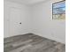 This bedroom features a window and attractive and durable wood-look floors at 4112 E Ellicott St, Tampa, FL 33610