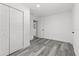This bedroom features wood-look flooring, a closet, and white walls at 4112 E Ellicott St, Tampa, FL 33610