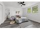 This lovely bedroom features modern decor, two windows and wood-look floors at 4112 E Ellicott St, Tampa, FL 33610