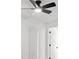 Close-up of ceiling fan with light in room with white walls and wood-look floors at 4112 E Ellicott St, Tampa, FL 33610