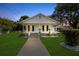 Welcoming home with a cozy covered porch, pristine lawn, and easy access walkway at 4112 E Ellicott St, Tampa, FL 33610