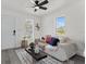 A stylishly decorated living room featuring ample natural light and hardwood floors, creating an inviting atmosphere at 4112 E Ellicott St, Tampa, FL 33610