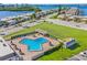 Aerial view of a community pool with lounge chairs and manicured grounds at 587 Boca Ciega Point N Blvd, St Petersburg, FL 33708