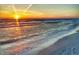 Beautiful beach with clear water and golden sunset, creating a serene and picturesque landscape at 587 Boca Ciega Point N Blvd, St Petersburg, FL 33708