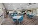 Spacious dining area featuring round tables, blue chairs, and stylish flooring, perfect for gatherings at 587 Boca Ciega Point N Blvd, St Petersburg, FL 33708