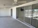 Spacious patio with ceiling fans and sliding glass doors overlooking the water at 587 Boca Ciega Point N Blvd, St Petersburg, FL 33708