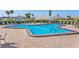 Community swimming pool surrounded by lounge chairs, and manicured lawn, ideal for outdoor enjoyment at 587 Boca Ciega Point N Blvd, St Petersburg, FL 33708
