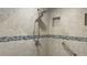 Nicely tiled shower with dual shower heads, grab bars, and recessed niche at 587 Boca Ciega Point N Blvd, St Petersburg, FL 33708
