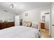 Well lit bedroom with hardwood floors and direct access to the bathroom at 7608 Pasa Dobles Ct, Tampa, FL 33615