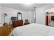 This bedroom features wood floors, a dresser, and a large closet at 7608 Pasa Dobles Ct, Tampa, FL 33615