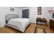 This bedroom has a large bed, desk, and hardwood floors at 7608 Pasa Dobles Ct, Tampa, FL 33615