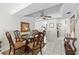 Cozy dining room with a glass table, wooden chairs, a ceiling fan and an view to the kitchen at 7608 Pasa Dobles Ct, Tampa, FL 33615