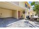 Exterior view of a townhouse with covered parking, a decorative wreath, and charming curb appeal at 7608 Pasa Dobles Ct, Tampa, FL 33615