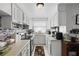 Functional kitchen with white cabinets, neutral countertops, and essential appliances at 7608 Pasa Dobles Ct, Tampa, FL 33615