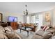 Bright living room with a comfortable couch, chandelier, and sliding glass doors leading to the patio at 7608 Pasa Dobles Ct, Tampa, FL 33615