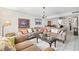Inviting living room with comfortable seating, decorative pillows, and a view of the dining area at 7608 Pasa Dobles Ct, Tampa, FL 33615