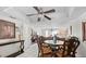 Open-concept living room and dining area with tile floors, a ceiling fan, and contemporary decor at 7608 Pasa Dobles Ct, Tampa, FL 33615