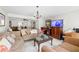 Spacious living room featuring comfortable furniture, a flat-screen TV, and stylish decor at 7608 Pasa Dobles Ct, Tampa, FL 33615