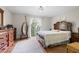 Spacious main bedroom with a large bed, dresser, and natural light from the windows at 7608 Pasa Dobles Ct, Tampa, FL 33615