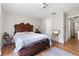 Main bedroom with hardwood floors, a large bed, and ample space for relaxation at 7608 Pasa Dobles Ct, Tampa, FL 33615