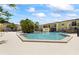 Large community pool surrounded by residential buildings and greenery at 7608 Pasa Dobles Ct, Tampa, FL 33615