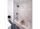 Renovated bathroom features black fixtures, marble-look tile shower and mosaic patterned floor tile at 811 40Th S Ave, St Petersburg, FL 33705