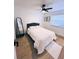 Bright bedroom with a ceiling fan, wood-look floors, a full length mirror and a neutral color scheme at 811 40Th S Ave, St Petersburg, FL 33705
