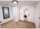 Hallway featuring wood-look floors, a linen closet, and an open doorway to a bedroom at 811 40Th S Ave, St Petersburg, FL 33705