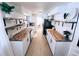 Updated kitchen featuring white cabinetry, open shelving, modern appliances, and wood countertop at 811 40Th S Ave, St Petersburg, FL 33705