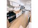 Updated kitchen featuring white cabinetry, modern appliances, open shelving, and wood countertops at 811 40Th S Ave, St Petersburg, FL 33705