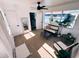 Bright sunroom featuring wood-look floors, a ceiling fan, and a cozy seating area with windows overlooking the yard at 811 40Th S Ave, St Petersburg, FL 33705