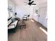Bright sunroom featuring wood-look floors, neutral walls, a ceiling fan, and a cozy seating area with bright, natural lighting at 811 40Th S Ave, St Petersburg, FL 33705