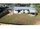 Aerial view of fenced-in backyard, offering a patio, covered space, and ample green space at 8524 Fish Lake Rd, Tampa, FL 33619