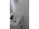 Bathroom sink with black faucet, white vanity and modern lighted mirror at 8524 Fish Lake Rd, Tampa, FL 33619