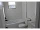 Bright bathroom with white subway tile and tub, plus white vanity at 8524 Fish Lake Rd, Tampa, FL 33619