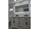 Modern bathroom featuring a double vanity, marble countertop, and illuminated mirror at 8524 Fish Lake Rd, Tampa, FL 33619