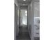 Hallway with modern gray laminate flooring, leading to the kitchen at 8524 Fish Lake Rd, Tampa, FL 33619