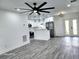 Bright, open kitchen featuring white cabinets, modern lighting, stainless steel appliances, and stylish gray flooring at 8524 Fish Lake Rd, Tampa, FL 33619