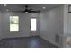 Bright living room features new gray flooring, white walls, and a modern ceiling fan at 8524 Fish Lake Rd, Tampa, FL 33619