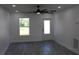 Living room with natural light, modern ceiling fan, and wood-look flooring at 8524 Fish Lake Rd, Tampa, FL 33619