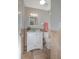 Bathroom with a white vanity, neutral tile and a functional toilet at 8610 Fish Lake Rd, Tampa, FL 33619