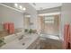 Bathroom featuring vanity sink, toilet, bathtub with shower, and neutral tile walls at 8610 Fish Lake Rd, Tampa, FL 33619