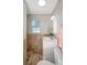 Bright bathroom featuring a vanity, toilet, neutral wall and floor tiles at 8610 Fish Lake Rd, Tampa, FL 33619