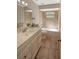 Bathroom with tile floor, neutral tile walls, tub and shower, and vanity sink at 8610 Fish Lake Rd, Tampa, FL 33619