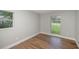 A clean bedroom with neutral walls, floors and a large window at 8610 Fish Lake Rd, Tampa, FL 33619