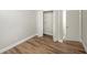 Bedroom featuring wood floor and open closet with shelf at 8610 Fish Lake Rd, Tampa, FL 33619