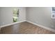 Bright bedroom with neutral walls, flooring and ample natural light from the large window at 8610 Fish Lake Rd, Tampa, FL 33619