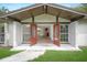 View of the home's interior through open double doors, showcasing the wood floors and layout at 8610 Fish Lake Rd, Tampa, FL 33619